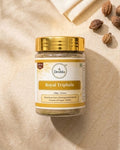 Jar of Deshla Royal Triphala on a beige background with gold lid