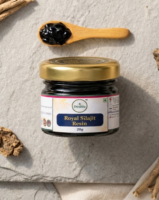 Jar of Royal Silajit Resin with a wooden spoon on a textured surface