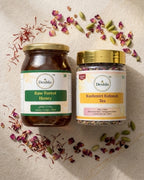 Two jars of Deshla honey and Kashmiri Kahwah tea on a textured surface with dried herbs.