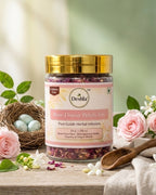 Jar of Deshla Rose Flower Petals Tea on a wooden surface with flowers and a nest in the background